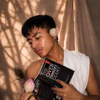 Holding a flower, but carrying a thousand unspoken thoughts.