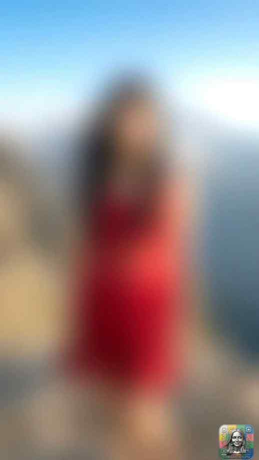 Sheer red dress against majestic snow-capped mountain peaks.