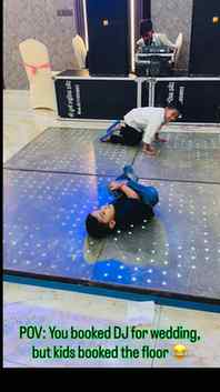Two cute toddler boys playing and rolling on colorful LED da