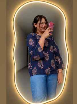 Transform the uploaded mirror selfie into a luxury LED mirro