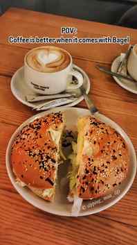 Warm coffee, toasted bagel, and a quiet table while it rains