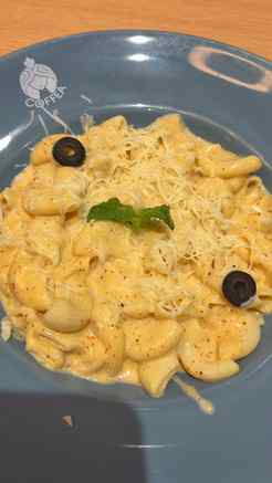 A cheesy bowl of mac & cheese and a hazelnut iced coffee on